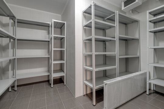 rows of metal shelves in fridge wardrobe. refrigerator for storing large amounts of food