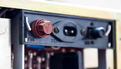 a brown fuse holder on the back panel of the old tape recorder