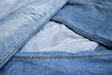 Fototapeta premium Lots of jeans pants in a stack. Denim background.