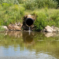 a pipe through which polluted water flows in nature.