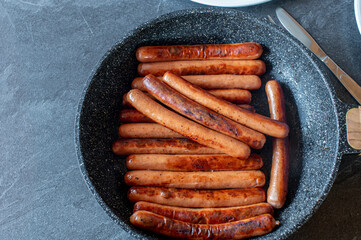 Fried vienna sausage in a frying pan