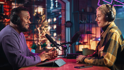Stylish Podcast Host Makes Radio Show Interview with Up-and-Coming Young Artist in Loft Studio Apartment. Handsome African American DJ Discussing Lifestyle Trends with Beautiful Colleague.