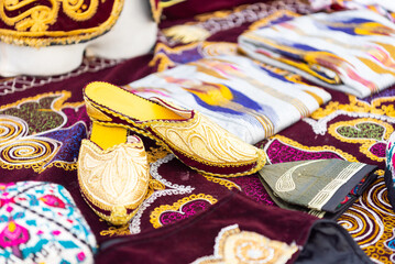 Fototapeta premium National shoes at the festival of the peoples of the world. Bright patterns and motifs in the ornament. Swap meet.