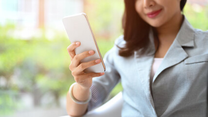  Smiling asian woman using mobile phone, communicating in social network