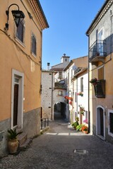 A narrow street between the old stone houses of Cansano, a medieval village in the Abruzzo region of Italy.	