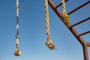 Climbing rope in station made for climbing training in selective focus. Military training, athlete training concept.