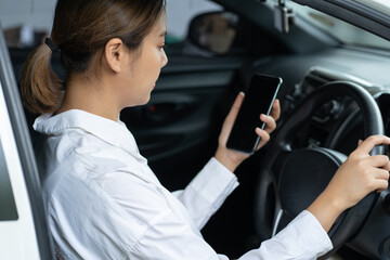 Asian women using smartphone while driving