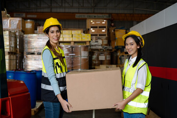 Women warehouse employee worker enjoy working with friend at workplace, teamwork concept.
