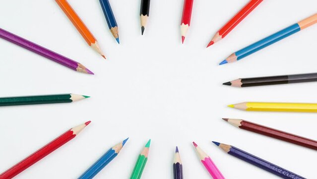 Stop motion animation with colored pencils moving moving in a fun circle. Time-lapse animation of colorful school pencils and fun pictures. Education concept
