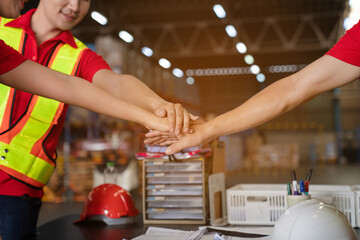 Closeup of team staff workers and supervisor join hands together in warehouse, success collaboration concept