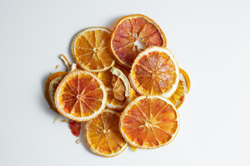 Fototapeta na wymiar Natural Dried Oranges Slices Snack. Dried Oranges for baking. Dried grapefruit, slices and dried candie citrus fruit. Isolated white background.