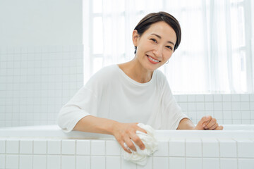 バスタブを掃除をする日本人女性