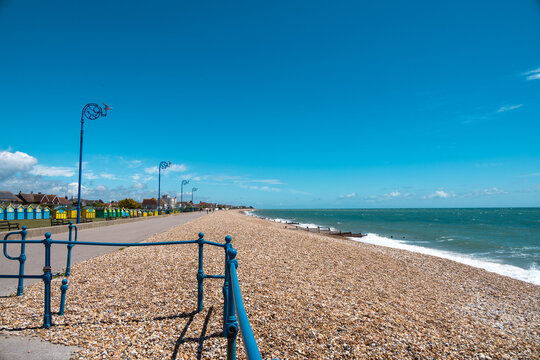 Shades of blue. A day in the british south coast, in Felpham, near brighton. View of the beach of pebbles or rocks ,bright blue sea and sky, sunny day. Beautiful summer day in Britain.
