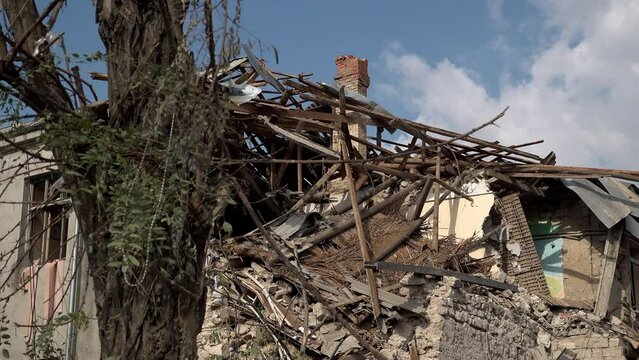 A tree stands in front of a destroyed primary school that was hit with a Russian missile during the war in Ukraine.