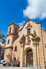 Fototapeta na wymiar Nice facade with tower and bell tower of the church of Santa Eulalia in Murcia, in baroque style