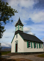 THINGVALLAKIRKJA, first church built in Iceland, beautiful wooden chapel house in a forest with blue sky