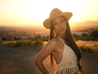 Brunette in countryside at sunset