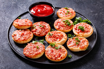 mini pizzas with ham and pecorino cheese, top view