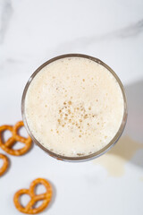 Top view of beer in glass foam and snacks