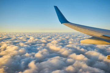 View of the beautiful sky and clouds from the window of the airplane. Sunset sky from the window of the airplane.