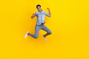 Fototapeta na wymiar Full size photo of excited crazy person raise fists listen favorite song isolated on yellow color background