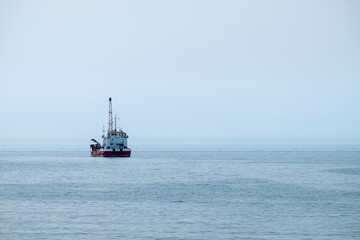 Hopper dredger vessel in the sea