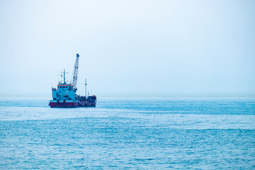 Hopper dredger vessel in the sea