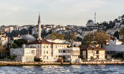 Fototapeta na wymiar Istanbul, Turkey - April 2022: View of a district in Asian part of Istanbul. View from a cruise ship on Bosporus Strait