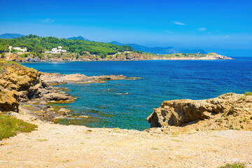 Panoramic view from Rec de Canet beach of Punta s'Aranella. Coastal road from Port of Selva to Llança. Costa Brava, Catalonia, Spain