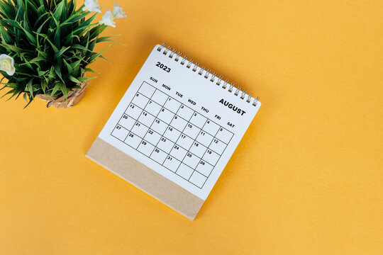 August 2023 desk calendar on yellow background. Directly above. Flat lay.