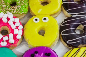 Bright, colorful donuts with colored glaze.