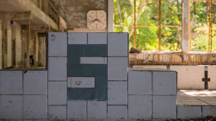 Jumping starting block with number five. Swimming pool inside destroyed abandoned building House of...