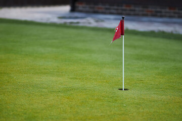lawn with red flag golf hole. Links 