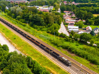 Fototapeta na wymiar Aerial view of freight train wagons on large railway track field. Concept of modern logistics. Coal delivery