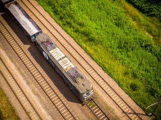 Aerial view of freight train wagons on large railway track field. Concept of modern logistics. Coal...