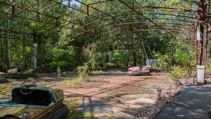 Rusty metal radioactive children's electric cars after explosion fourth reactor Chernobyl nuclear...