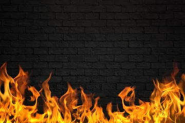 Fototapeten Feuer & Flamme Black brick wall with fire flame for background  © naiaekky