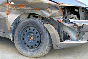 A fragment of a car damaged in an accident on a summer day