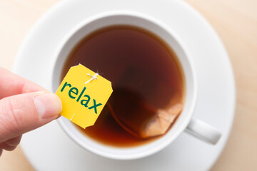 Top down view of cup of tea with the word 'relax'