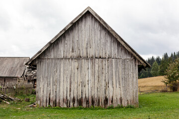 Fototapeta na wymiar Old barn made of vertical planks.