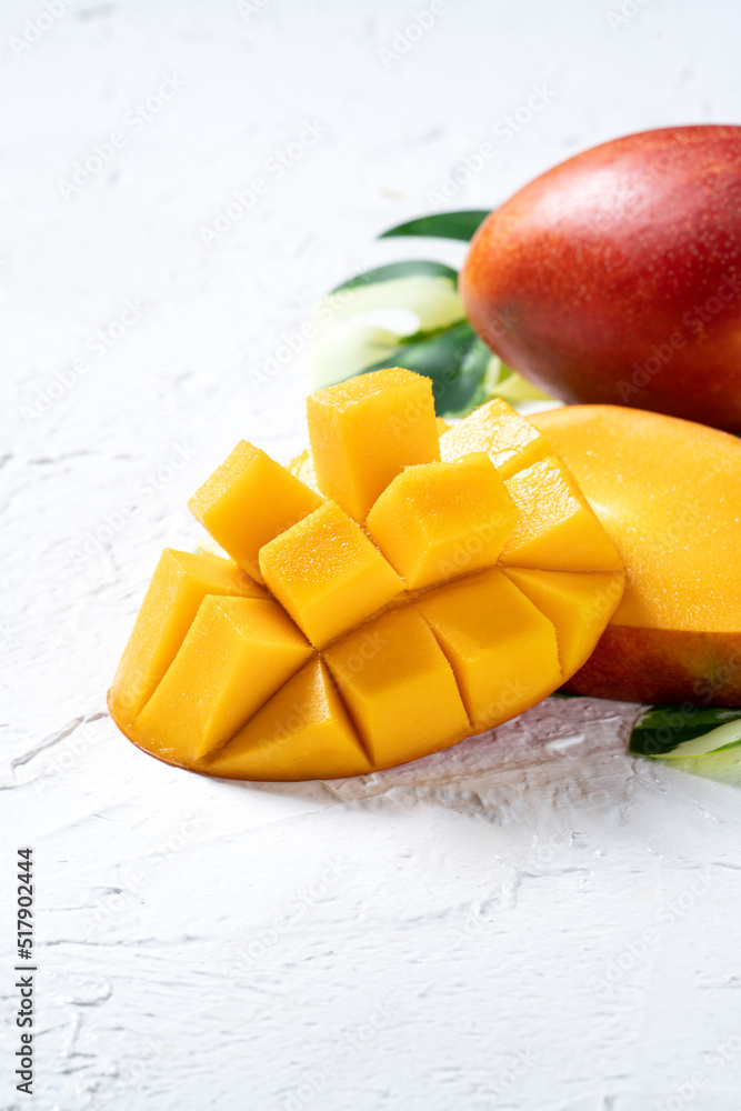 Wall mural mango background design concept. top view diced fresh mango fruit on white table.