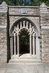 Ornate Stone Masonry Entrance to Church Garden in Sunlight