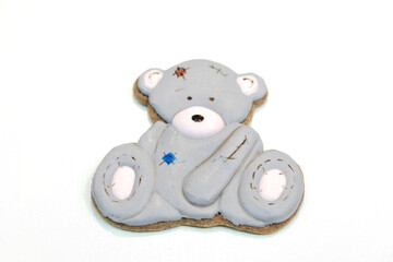 Gingerbread in the shape of a gray teddy bear on a white background