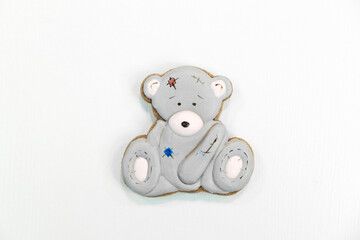 Gingerbread in the shape of a gray teddy bear on a white background