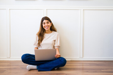 Hispanic woman feeling happy to work from home with a laptop