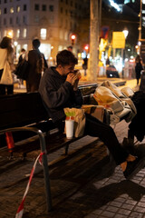 Hungry homeless guy biting burger