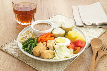 Gado Gado, Indonesian traditional vegetable salad with peanut sauce, rice cake, tofu and egg
