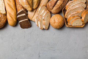 Homemade natural breads. Different kinds of fresh bread as background, top view with copy space