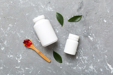 different drugs and health supplement pills with medicine bottle health care and medical top view. Vitamin tablets. Bottle with colored pills on table background. Multivitamins