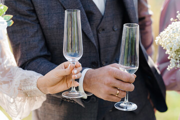 bride and groom holding glasses
